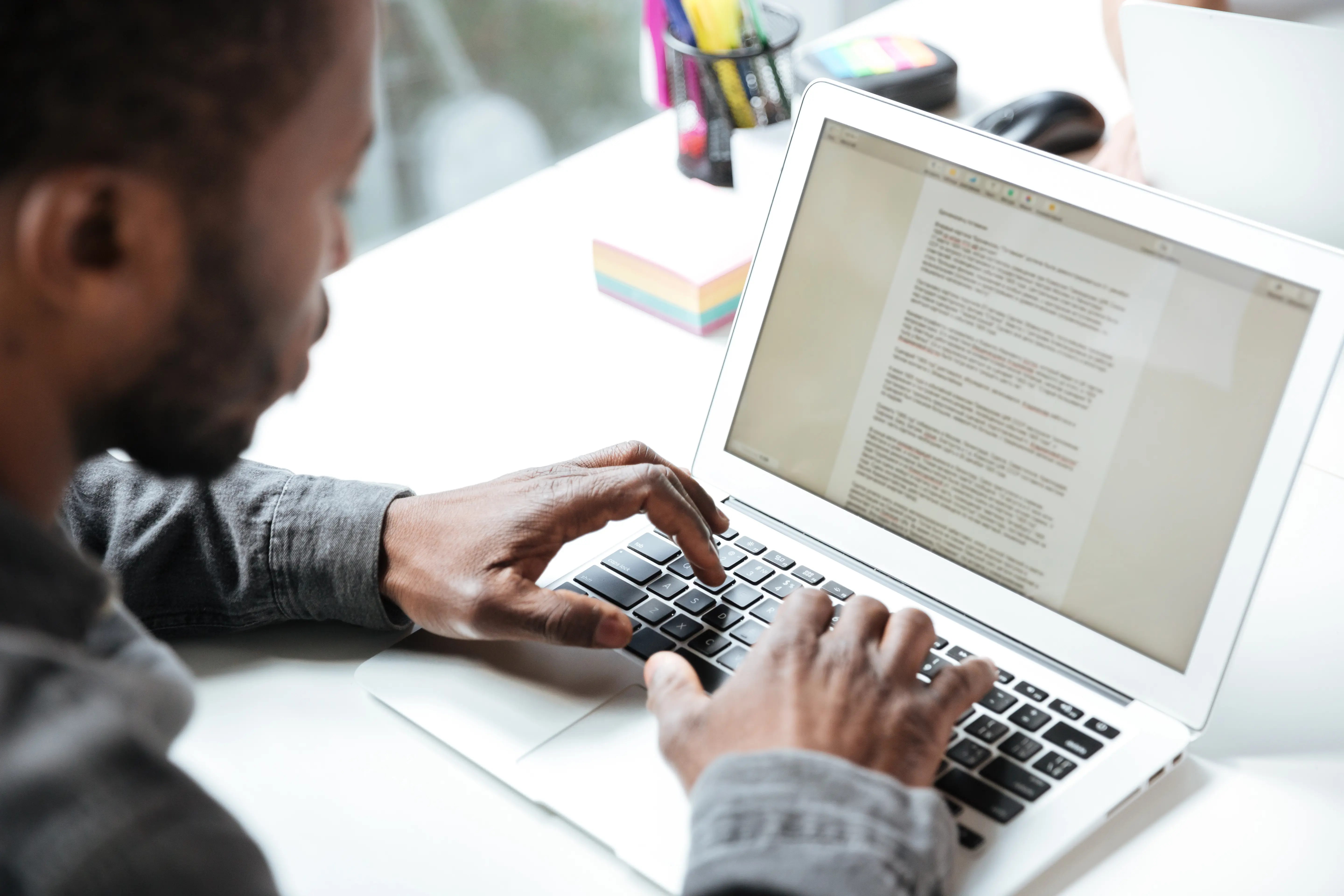 a person typing on laptop doing copywriting